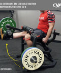 Person using Leg Extension And Curl Machine for home or commercial gyms, plate loaded quad and hamstring trainer, leg extension position