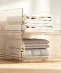 Xlarge Stackable Storage Bins 2 Pack Clear Crystal PET Baskets for Max Vertical Closet Space to Keep Your Setup Dope and No Clutter Allowed for Anyone Keeping It Proper and Clean, holding stacked towels.