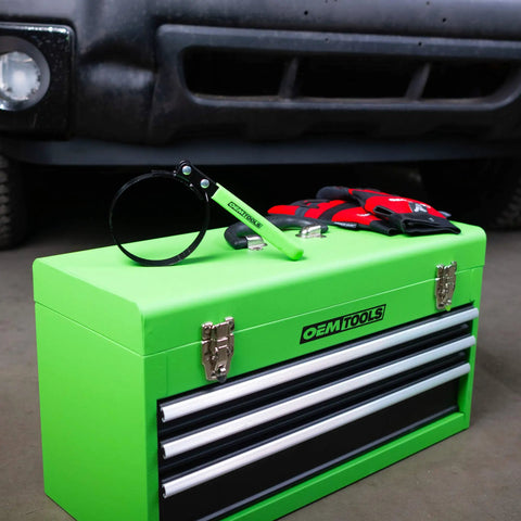 Adjustable Oil Filter Wrench For Spin On Filters Two And Three Quarters To Three And One Quarter Inches on green toolbox