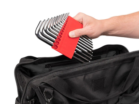 Hand holding Ball End Hex Key Set With Holders, 28 Piece Inch And Metric Allen Wrenches In Chrome Finish, placing into bag.