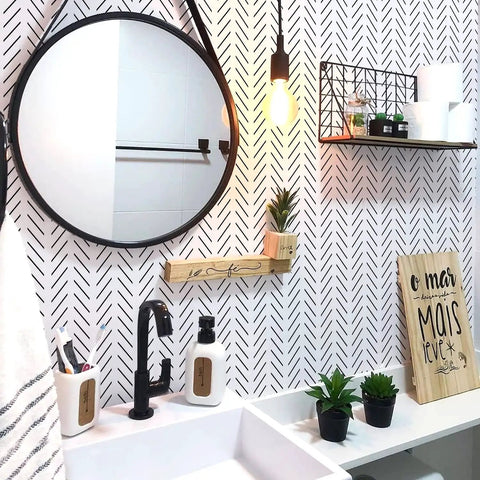 Bathroom with Black And White Peel And Stick Wallpaper Geometric Herringbone Vinyl Self Adhesive Contact Paper, round mirror, and plants.