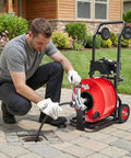 Heavy Hitter Auto Feed Drain Cleaner With 100 Ft Steel Pipe Snake and Zippy Motor in use for sewer cleaning outdoors.