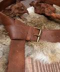 Dual Brown Renaissance Belt Pouch And Viking Bracer Kit Featuring detachable brown leather belt with brass buckle on fur background.