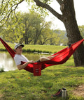 One Person Camping Hammock With Durable Ripstop Fabric And Heavy Duty Straps For Up To 300 Lbs in use by a lake
