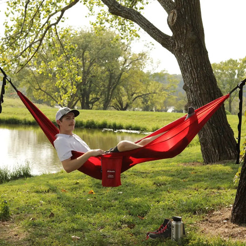 One Person Camping Hammock With Durable Ripstop Fabric And Heavy Duty Straps For Up To 300 Lbs in use by a lake