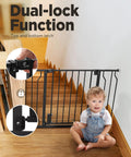 Child sitting by adjustable baby gate with dual-lock feature, 29.5 to 41.3 inches, 30-inch tall metal safety gate for stairs and doorways.
