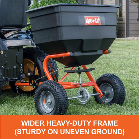 Tow Behind Lawn And Garden Broadcast Spreader With 185 Lb Capacity, Tackles Seed Fertilizer Salt Ice Melt, 12 Ft Spread attached to mower