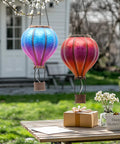 Set Of 2 Dope Hot Air Balloon Solar Lanterns For Outdoor Garden Decor, 18 Inch hanging in backyard, with gift box on table.