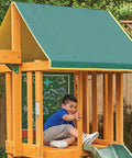 Child playing on shaded upper deck of Weatherproof Wooden Swing Set For Backyard With UV And Mold Protection, Durable Pre Treated Lumber