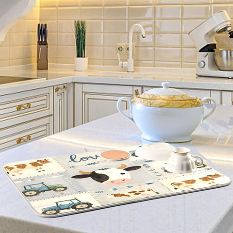 Farm Themed Dish Drying Mat With Cows And Tractor Design, Extra Large 18x24 Inches on kitchen counter catching drips from dishes.