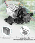12V RV Water Pump Self Priming With 4 GPM At 45 PSI And Pressure Switch Plug And Play Kit, hoses visible with garden in background.