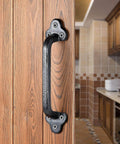 Rustic 9 Inch Cast Iron Sliding Barn Door Handle 2 Pack Black Vintage Gate Pull for interior doors in a kitchen setting.