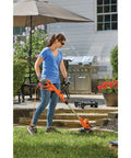 Woman using 3-In-1 Electric Lawn Mower Weed Eater And Edger For Small Yards Corded 12-Inch 6.5 Amp Powerdrive Motor outdoors