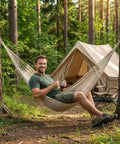 Man relaxing in Two Person Hammock 79 By 59 Inches Cotton Rope Outdoor Camping Hammock With 550 Lb Weight Capacity