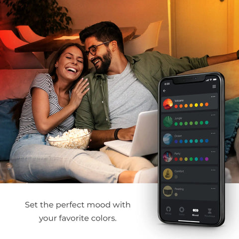 Couple in a cozy living room setting with phone app controlling No Hub Smart LED Bulb With Multicolor Spiral Filament WiFi Connected.