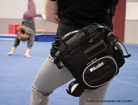 Athletic Trainer Sling Bag for Medical Supplies Compact Over the Shoulder First Aid Kit Black One Size in use at a gym.