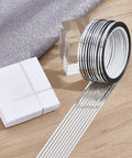 Premium Metallic Mirror Trim Tape Heavy Duty Pet Self Adhesive Roll Kicking Up Your Craft Game With Durable 546 Yard Run rolled on wooden surface with gift box and glitter