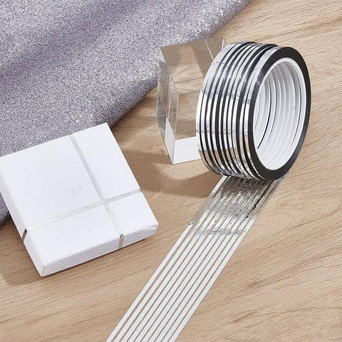Premium Metallic Mirror Trim Tape Heavy Duty Pet Self Adhesive Roll Kicking Up Your Craft Game With Durable 546 Yard Run rolled on wooden surface with gift box and glitter