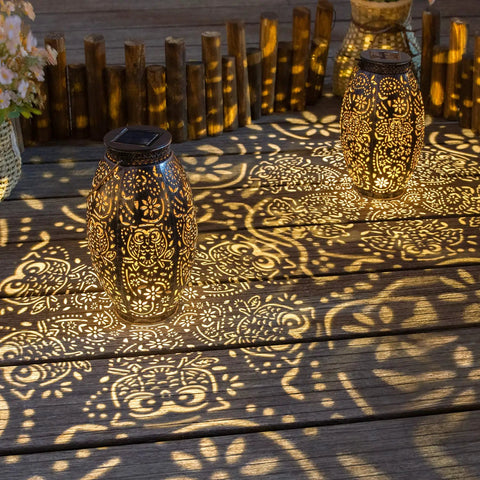 Two Pack Owl Solar Lanterns Outdoor Lights Waterproof Large Antique Bronze Garden Decor projecting patterns on wooden surface