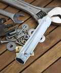 Premium Steel Water Heater Element Socket Wrench For RV Trailers And Campers With Ergonomic Tubular Handle placed among tools and hardware on wooden surface.