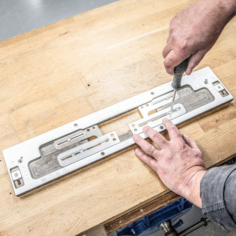 No Fuss Adjustable Door Latch And Strike Plate Router Jig Featuring Knockout Precision and Dual Layer Aluminum Plates on workbench.