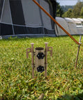 Six Piece Adjustable Camping Tarp Poles And Sand Stakes Kit with aluminum tent pegs and khaki pole holders on grass