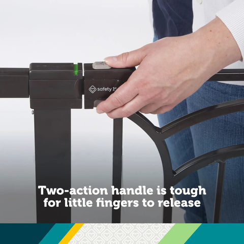 Hand securing lock on tall and wide baby gate for doorways with easy install no drilling and pressure mount decor friendly design