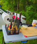 Grill Caddy For Outdoor Grill And BBQ Magnetic Tool Holder With Paper Towel Arm on picnic table with utensils and condiments