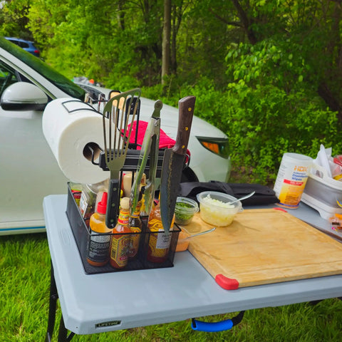 Grill Caddy For Outdoor Grill And BBQ Magnetic Tool Holder With Paper Towel Arm on picnic table with utensils and condiments