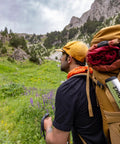 Hiker carrying gear in mountain landscape, Award Winning Ultra Lightweight Aluminum Backpacking Shovel For Camping And Hiking