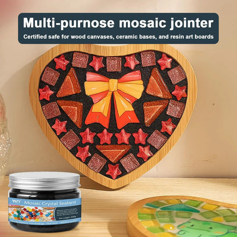 Heart-shaped mosaic with colorful tiles using Mosaic Grout For Crafts Black 400g Quick Dry Crystal Tile Grout, jar in foreground.