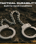 Real Deal Stainless Steel Leg Irons With 16 Inch Twist Chain Double Lock Restraints Police Grade Shackles lying on textured surface.