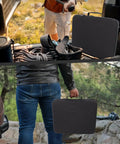 Rugged Travel Case For Mini Dish Kit With Shockproof IP67 Waterproof EVA Storage held by person next to vehicle outdoors.