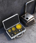 Solid 10-Piece Diamond Hole Saw Kit With Multi-Size Drill Bits For Shattering Glass Tile And Marble Like A Boss In Any Home Reno Job. open case with yellow diamond hole saw bits and cut metal plates