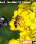 Top Tier 48MP USB Webcam Pumping Out Straight Fire 8K Ultra HD Video With 5 To 50MM 10X Manual Zoom Lens on yellow flowers.