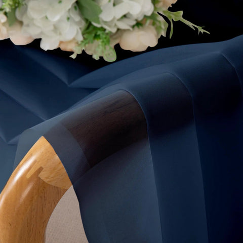 Close-up of Pure Sheer Window Curtains 72 Inch Long 2 Panels Navy Blue Voile Drapes, highlighting fabric texture on chair.