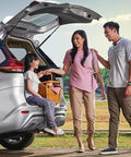 Family with open SUV trunk enjoying picnic outdoors