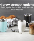 Table setting with blue, white, and black mugs, iced coffee, croissants, showcasing One Press Programmable Dispensing Drip Coffee Maker