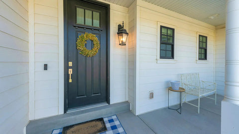 Front porch with black door, wreath, outdoor bench, and traditional light fixture next to outlet suitable for 1-Gang Weatherproof In-Use Outlet Cover Expandable Nonmetallic Flat Mount 16 In 1 Design Versatile Vertical Or Horizontal Install Gray 1 Pack UL Listed For Wet And Damp Locations Quick Fit.