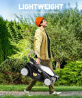 Person carrying Cordless Electric Lawn Mower For Medium Lawns Up To 1300 Sq Ft With 13.2 Inch Cutting Width, 8 Gallon Grass Bag