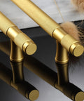 Close-up of Ten Pack Gold Knurled Cabinet Pulls With 5 Inch Hole Centers 7 Inch Overall Length Brushed Brass Handles on black surface.