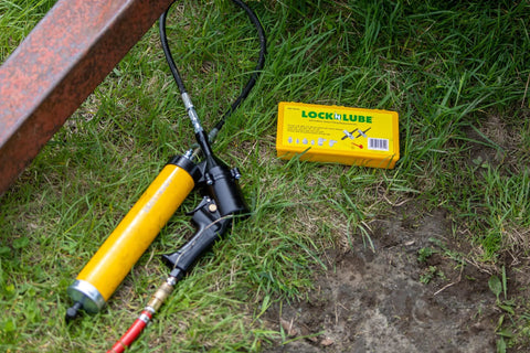 Lock-N-Lube grease fitting replacement kit in yellow case with SAE/metric zerks, multi-tools and caps