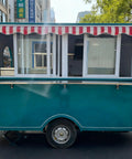 Rollout Ready Custom Towable Food Trailer Commercial Mobile Catering Kitchen With Insulated Walls Heavy Duty Chassis And Turnkey Layout To Fuel Your Street Food Hustle Or Weekend Crowd Pleaser, showing exterior with striped awning.