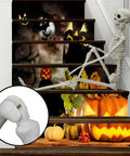 Halloween staircase with pumpkins, jack-o-lanterns, and skeleton decor