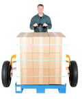 Heavy Duty All Terrain Steel Pallet Truck With Pneumatic Tires And Smooth Steering Glides Over Rough Ground Loads Up To Two Thousand Five Hundred Pounds Without A Sweat On Thirty Two Inch Forks Perfect Yard And Warehouse Workhorse transporting stacked boxes.