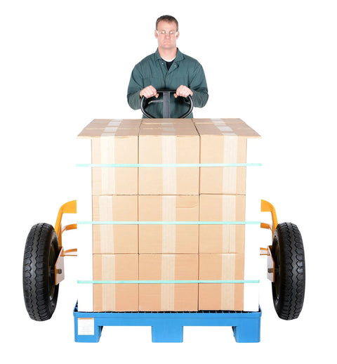Heavy Duty All Terrain Steel Pallet Truck With Pneumatic Tires And Smooth Steering Glides Over Rough Ground Loads Up To Two Thousand Five Hundred Pounds Without A Sweat On Thirty Two Inch Forks Perfect Yard And Warehouse Workhorse transporting stacked boxes.