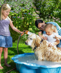Heavy Duty Garden Hose Nozzle With 10 Pattern Watering Sprays in use for pet bath in garden, bright orange red.
