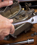 User using Three Eighth Inch Drive Ratchet And Drive Tools Set With Eighty Four Tooth Full Polish Chrome Ratchets on machinery