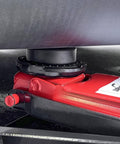 Tesla Jack Pad Set 4 Pack Rubber Lifting Pucks For Model 3 Y S X installed on a car chassis with a red heavy-duty jack