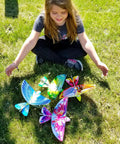 Girl playing with colorful Rad Flying RC Bird Toy For Kids With Realistic Flapping Wings And USB Recharge 2.4GHz Remote Control